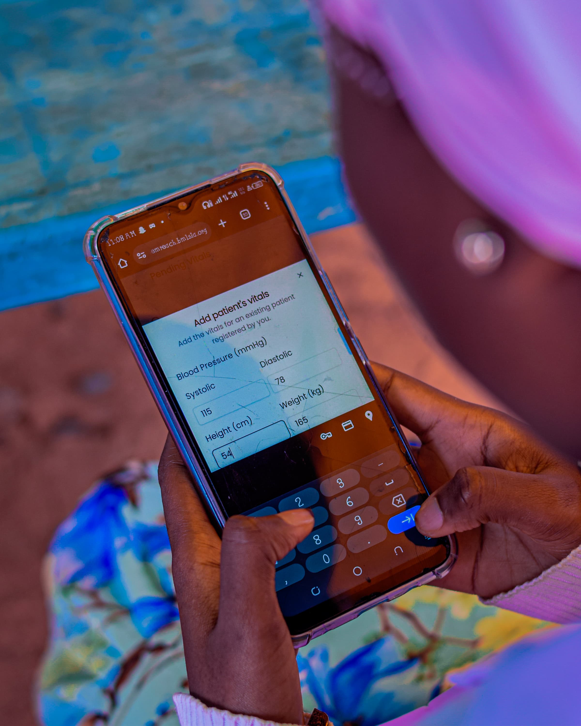 OutEMReach on a phone at an outreach